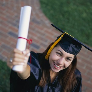 Smiling Graduate Holding up Diploma